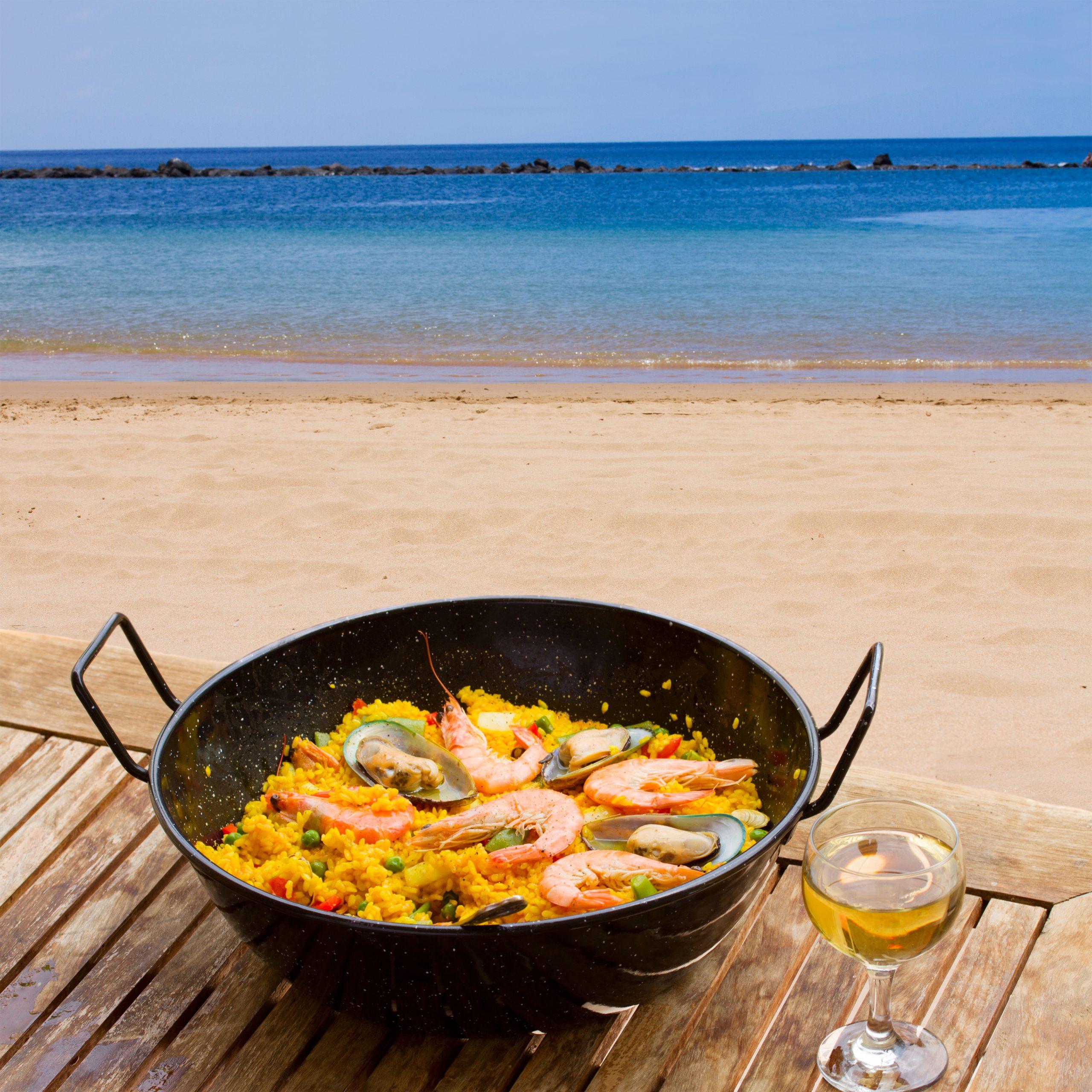Seafood,Paella,With,Glass,Of,Wine,In,Seaside,Cafe